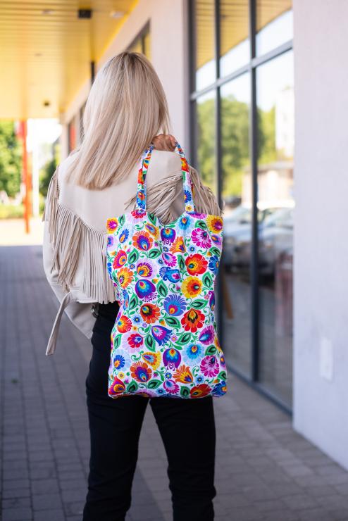 model is presenting folk white lowicz flowers cotton bag