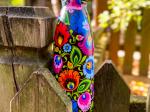 termo bottle decorated with black lowicz pattern next to basket filled with mushrooms