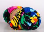 rolled up blanket with lowicz flowers on a black background
