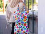 model is presenting folk white lowicz flowers cotton bag